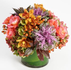 orange lilies and peach flowers in vase