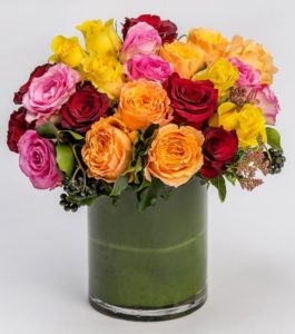 Allow our designers to create a custom, colorful assortment of all premium roses in our leaf-lined cylinder vase