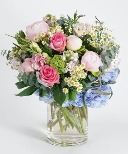 Bring the beauty of Spring indoors with this graceful collection of soft Spring blooms. Featuring seasonal favorites such as peonies, hydrangea and roses in sweet shades of pink, white and blue, this one-of-a-kind design is complemented by gardeny accents of chamomile, viburnum and eucalyptus.