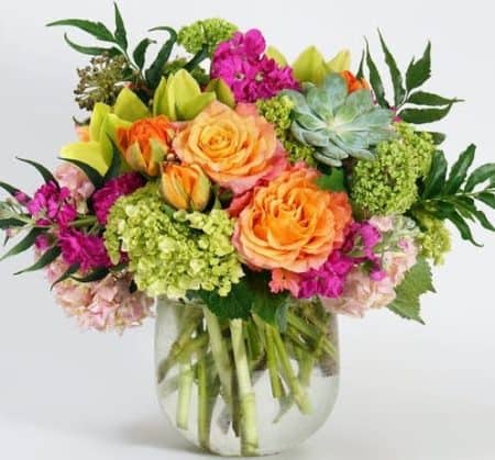 What better way to excite the senses than with a luxurious arrangement of refreshing, citrus toned blooms. Filled with a lush assortment of unique tones and textures including pink hydrangea, orange tulips, green orchids, succulents and Japanese holly fern - this one-of-a-kind design is sure to brighten any space.