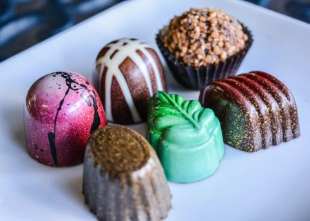 6 colorful gourmet chocolates on plate